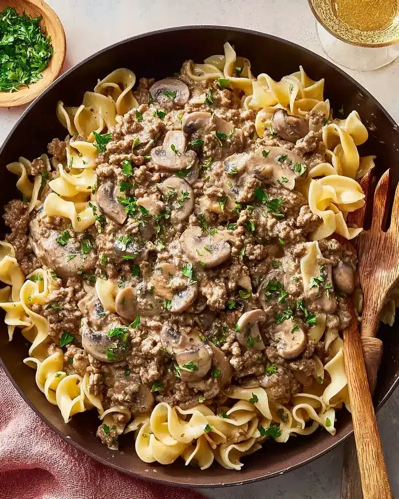 Ground Beef Stroganoff 3 Cooking process image: Ground beef stroganoff simmering in a skillet.